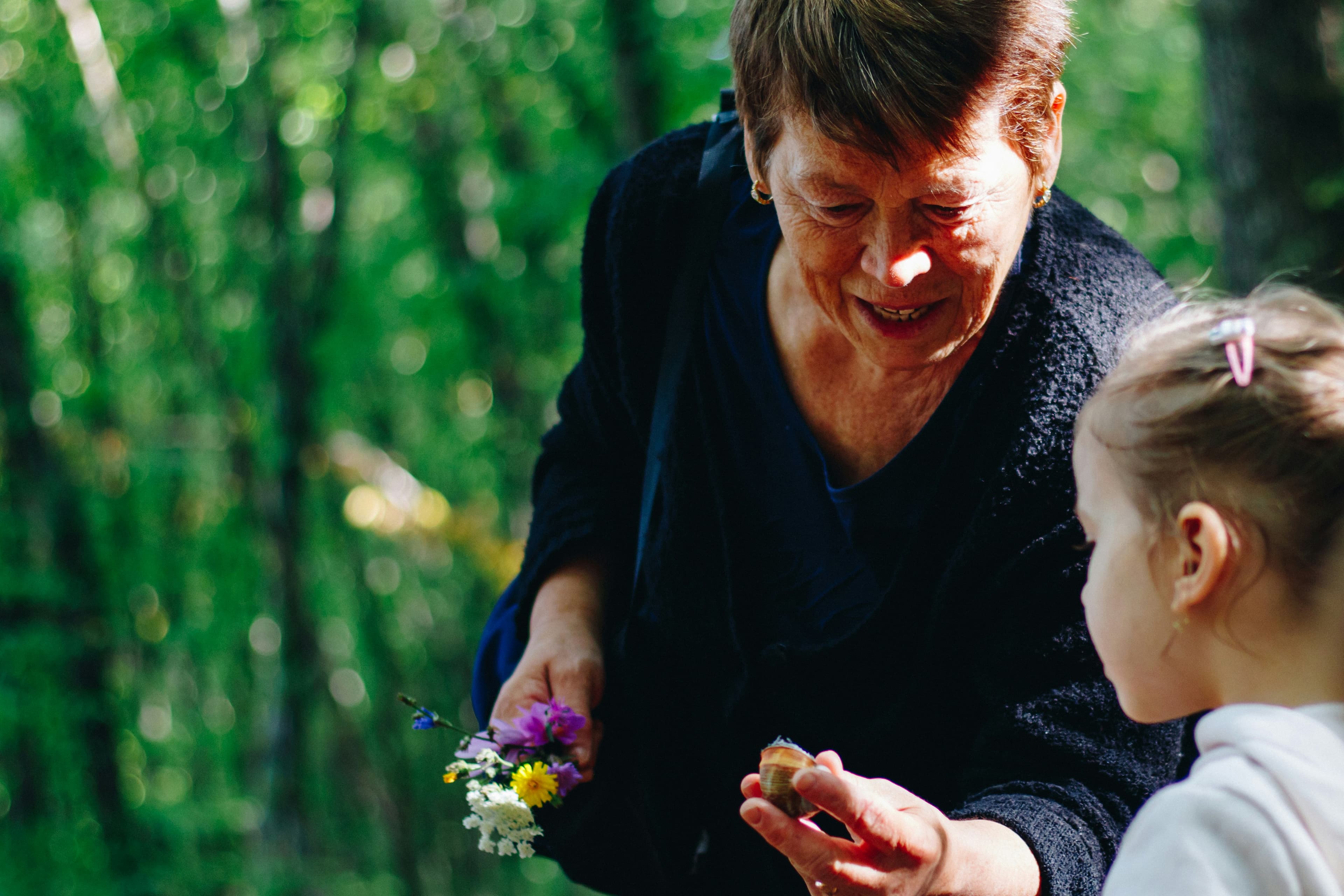 An older woman and a young child exploring outdoors together